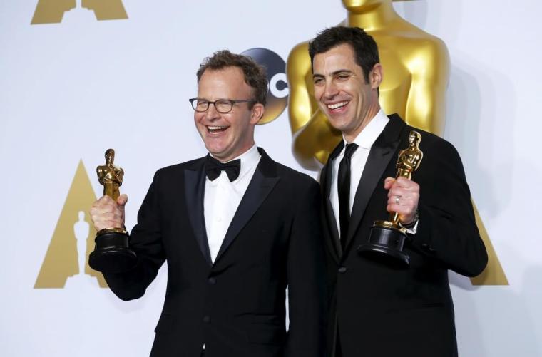 Tom McCarthy (L) and Josh Singer, winners of Best Original Screenplay for "Spotlight", pose backstage at the 88th Academy Awards in Hollywood, California, February 28, 2016.