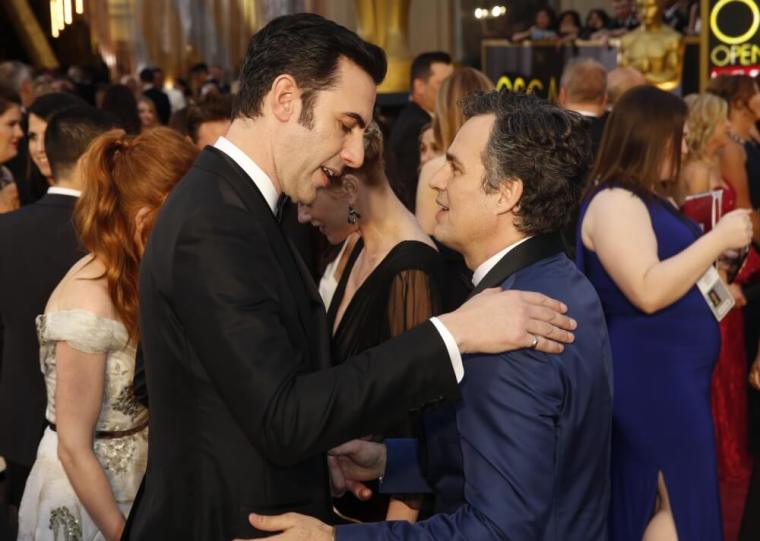 Presenter Sasha Baron Cohen talks with Mark Ruffalo (R), nominated for Best Supporting Actor for his role in "Spotlight," as they arrive at the 88th Academy Awards in Hollywood, California, February 28, 2016.