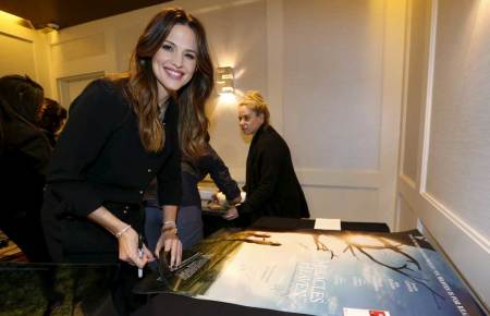 Cast member Jennifer Garner autographs posters at a photo call for the movie "Miracles from Heaven" in West Hollywood, California March 4, 2016.