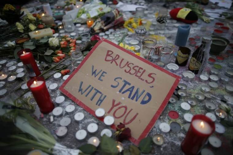 Candles are seen near a message, 