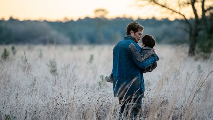 Roy holds his son Alton in a scene from Jeff Nichols' Sci-Fi thriller 