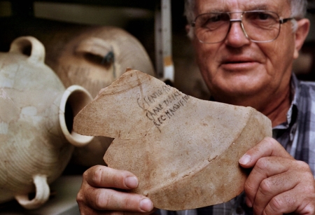 Israeli archaeologist Prof. Ehud Netzer displays the shard from a 2,000-year-old amphora bearing the name of
