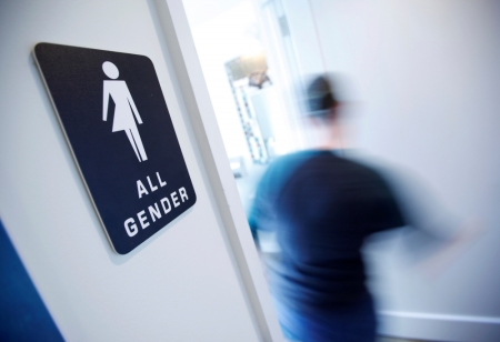 A bathroom sign welcomes both genders at the Cacao Cinnamon coffee shop in Durham, North Carolina, May 3, 2016. The shop installed the signs after North Carolina's 