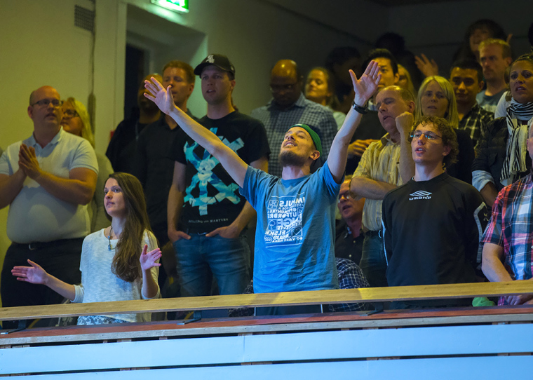 An attendee participates in a church service during Will Graham's recent visit to Norway.