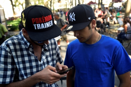 A man wears a Pokemon-themed hat as he plays the augmented reality mobile game "Pokemon Go" by Nintendo in Bryant Park, New York City, July 11, 2016.