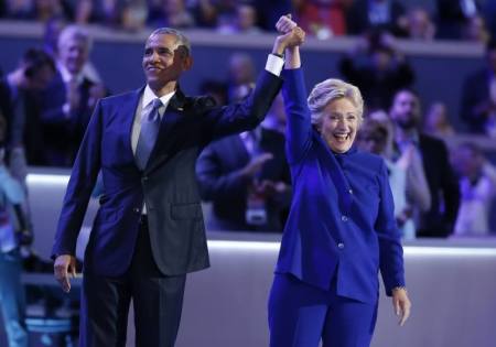 Democratic presidential nominee Hillary Clinton stands with President Barack Obama after his speech at the Democratic National Convention in Philadelphia, Pennsylvania, U.S. July 27, 2016.