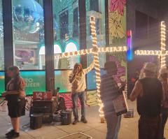 Street evangelist team assaulted by pedestrians in rainbow-painted sidewalk outside lesbian bar 
