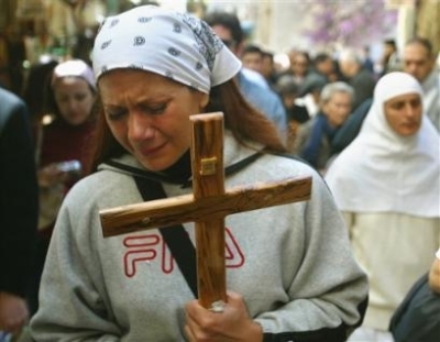 A Christian pilgrim cries as she and others walk along the Via Dolorosa, where Christians believe Christ walked on his way to his crucifixion, in east Jerusalem's Old City during Good Friday processions, Friday, March 25, 2005. (AP Photo/Brennan Linsley)
