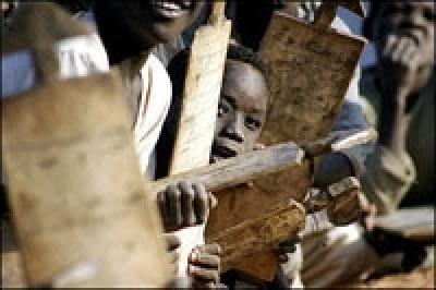 Sudanese displaced children attend a class at an outdoors makeshift school in Drage camp, on the outskirts of the southern Darfur town of Nyala, January 2005. Donors in Oslo, Norway pledged $4.5 billion in aid for Sudan on Tuesday, April 12, 2005. UN Secr