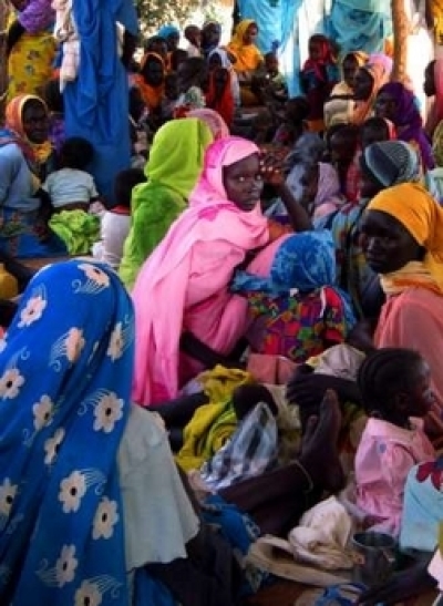 Sudanese refugee women wait for medical assistance for their children at the Primary Health Care center for malnourished children in Gereida town, 90kms (55.9 miles) south of Nyala town in Sudan's troubled Darfur province June 14, 2005. Doctors there have