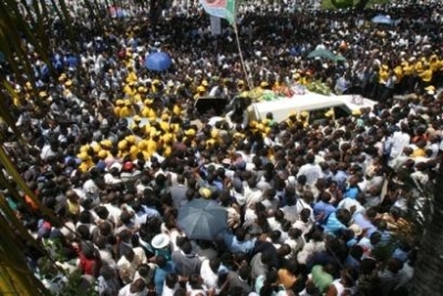 Workers of the Civil protection carry the coffin of slain popular radio pastor Rev. Jean-Moles Lovinksky Bertomieux, 43, in Port-au-Prince, Haiti, Sunday, Sept. 19, 2004. Thousands of Haitians gathered for the funeral of Berthomieux, whose daily morning b