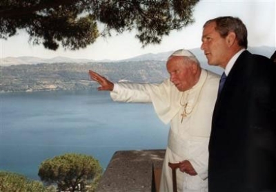 Pope John Paul II points to Lake Albano accompanied by President Bush, during their first meeting at the Pontiff's summer residence in Castel Gandolfo near Rome in this July 23, 2001 file photo. (Photo: AP / File / Arturo Mari)