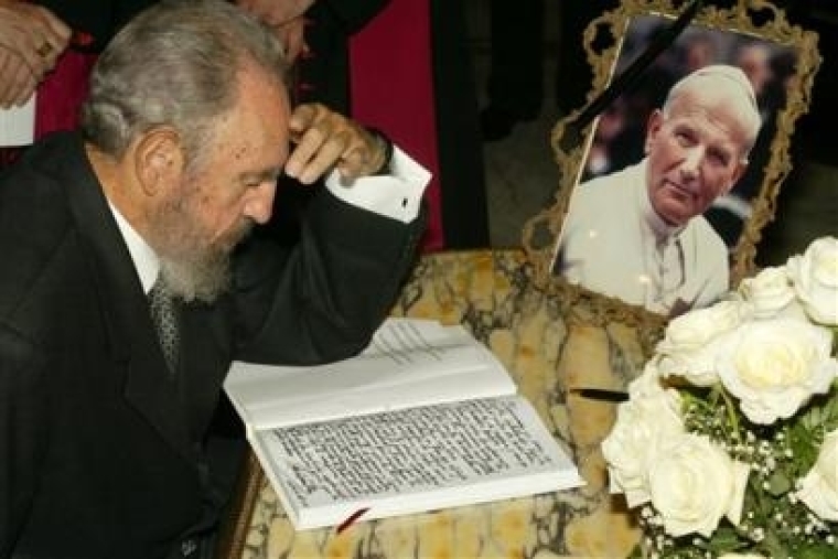 Cuban President Fidel Castro pauses as he signs the book of condolences for Pope John Paul II at the headquarters of the Catholic Nunciate in Havana, Cuba, Sunday, April 4, 2005 (AP Photo/Jorge Rey)