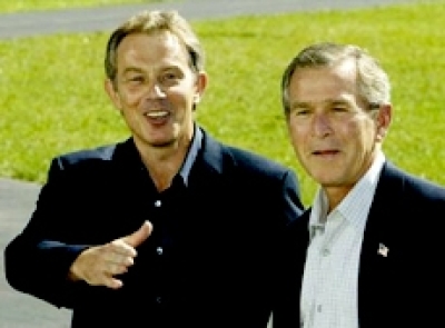 U.S. President George W. Bush and British Prime Minister Tony Blair seen at Camp David, the presidential retreat near Thurmont, Maryland, in this September 2002 file photo. REUTERS/Win McNamee