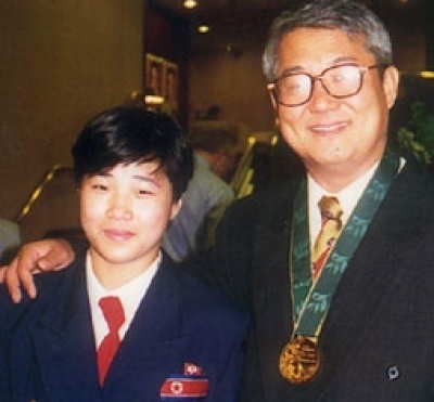 Pastor Kim Dong-shik (R) poses with North Korean judo champ Kye Sun-hui, who took gold in the 1996 Atlantic Olympic Games.
