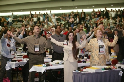 Delegates to the United Methodist Church's 2004 General Conference in Pittsburgh hold hands prior to a vote affirming unity in the church. The resolution on unity followed several days of contentious debate on the issue of homosexuality. A UMNS photo by M