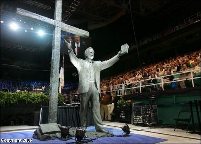 An 18-foot statue of the Rev. Billy Graham is shown after it was unveiled at the Southern Baptist Convention's annual meeting Wednesday night. The statue depicts Graham standing before a cross, with an evangelist's outstretched arms.