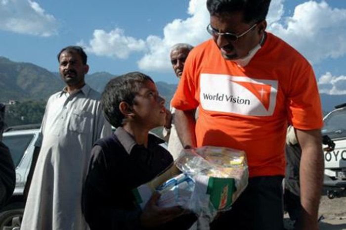 Amid desperate scenes, World Vision worked with local partners to distribute burial shrouds, quilts and water to survivors in Balakot, northeast Pakistan on Wednesday, October 12, 2005. (Photo: World Vision / James East)