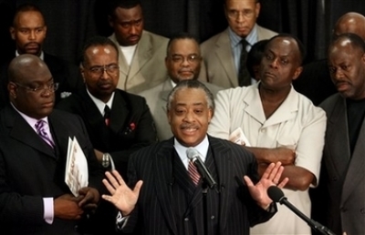 The Rev. Al Sharpton, center, speaks during a news conference at The National Conference and Revival for Social Justice in the Black Church at the Friendship-West Baptist Church in Dallas, Texas on Tuesday, June 27, 2006.
