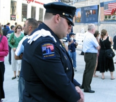 An officer pays tribute to the fallen of 9/11. At the official Sept. 11 Commemoration Ceremony held at Ground Zero, relatives of the fallen read the names of the 2,749 World Trade Center victims out loud.