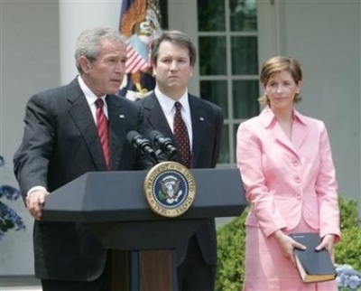 President Bush, speaks in the Rose Garden of the White House before the swearing-in of Brett Kavanaugh, center, as Judge for the U.S. Court of Appeals for the District of Columbia Thursday, June 1, 2006 in Washington. Holding the Bible is Kavanaugh's wife Ashely Kavanaugh. (Photo: AP / Pablo Martinez Monsivais)