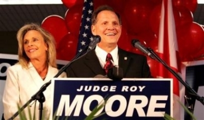 Roy Moore stands with his wife, Kayla, and addresses supporters at his campaign headquarters, Tuesday night, June 6, 2006, in Gadsden, Ala. Republican Gov. Bob Riley defeated Alabama's ousted Ten Commandments judge, Roy Moore, in the GOP primary Tuesday. (Photo: AP / Butch Dill)