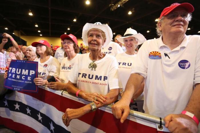 Supporters listen to Republican presidential nominee Donald Trump as he speaks at a campaign rally in Phoenix, Arizona, U.S., August 31, 2016.