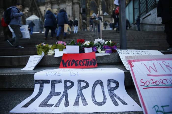 A placard reading 'Mrs Merkel, Mrs Kraft, this is terror. Where are you?' lies on the steps to Cologne Cathedral prior to a demonstration by anti-immigration right-wing movement PEGIDA (Patriotic Europeans Against the Islamization of the West) in Cologne, Germany, January 9, 2016.