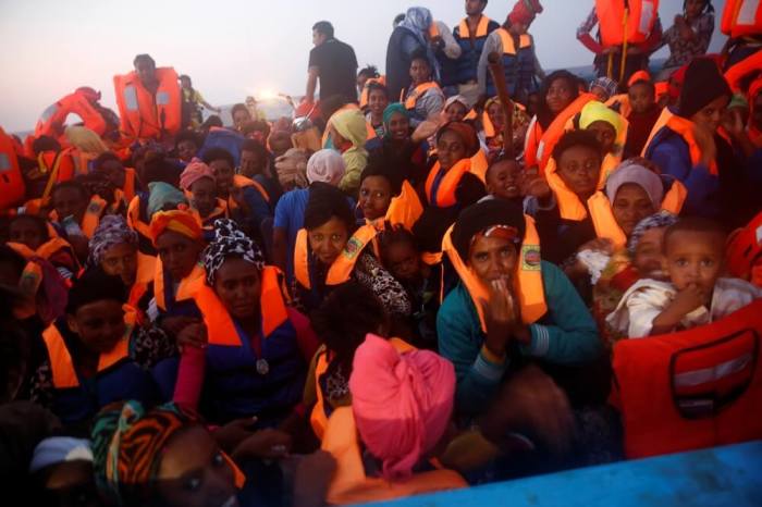 Migrants from Eritrea are seen on an overcrowded wooden vessel during a rescue operation by the Spanish NGO Proactiva, off the Libyan coast in Mediterranean Sea August 29, 2016.