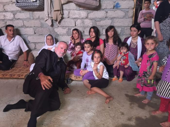 New York City Pastor Bill Devlin visits with Yazidi families in August 2016 in the Kurdish town of Dohuk, where he provided assistance to over 20 Yazidi families.