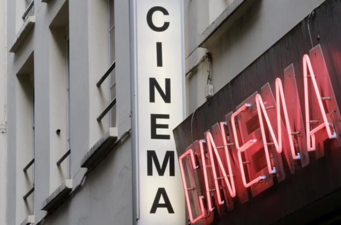 Cinema neon light signs are seen at the entrance of Le Beverley adult cinema in Paris July 30, 2014.