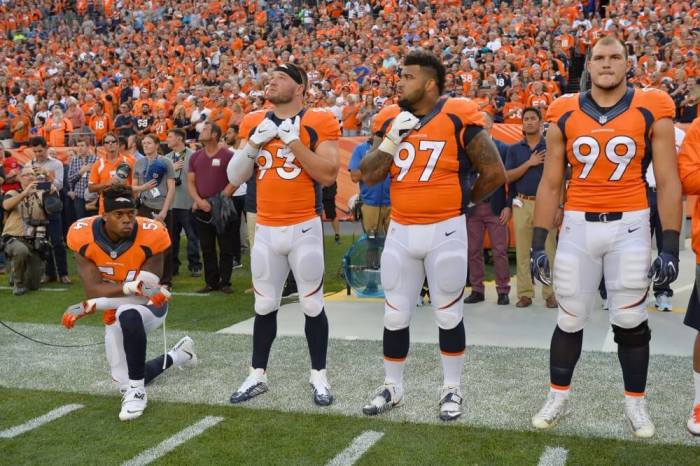 Sep 8, 2016; Denver, CO, USA; Denver Broncos inside linebacker Brandon Marshall (54) kneels during the national anthem next to defensive end Jared Crick (93) and defensive tackle Billy Winn (97) and defensive tackle Adam Gotsis (99) before the game against the Carolina Panthers at Sports Authority Field at Mile High.
