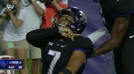 Texas Christian University quarterback Kenny Hill celebrates a touchdown by performing the "Rising Kings" sign language gesture during the Horned Frogs game against the University of Arkansas on Sept. 10, 2016.