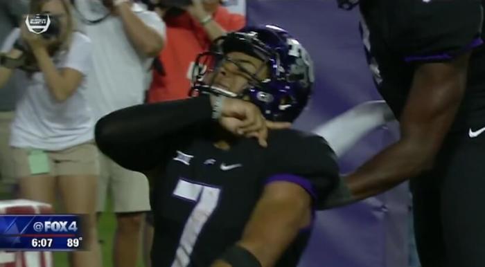 Texas Christian University quarterback Kenny Hill celebrates a touchdown by performing the 'Rising Kings' sign language gesture during the Horned Frogs game against the University of Arkansas on Sept. 10, 2016.