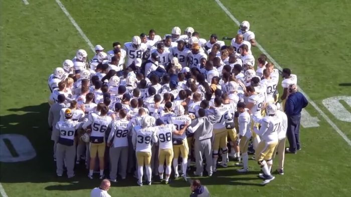 The Georgia Tech football team gathers in a huddle after a game during the 2014 season.