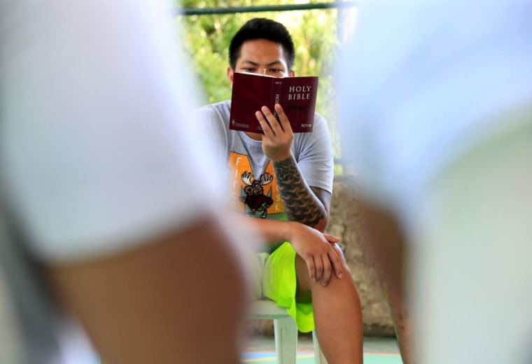 A drug user undergoing rehabilitation reads the Bible as part of his regular activities at the Center for Christian Recovery in Antipolo, Philippines, September 12, 2016.