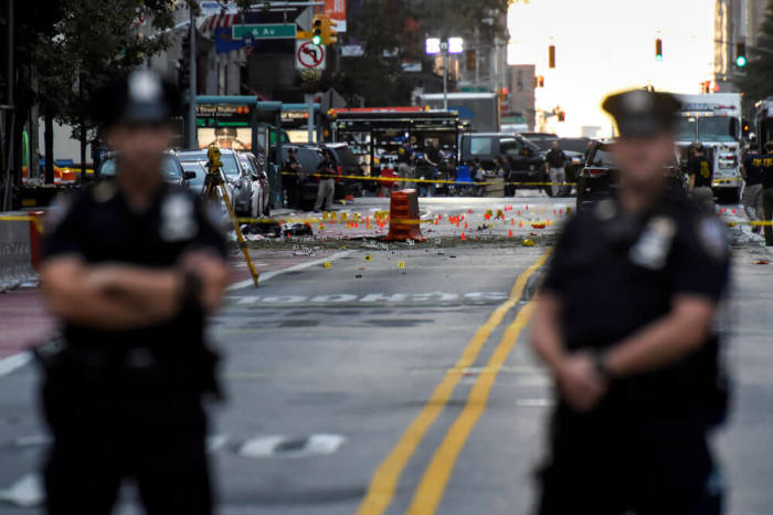 New York City Police Department officers stand near the site of an explosion in the Chelsea neighborhood of Manhattan, New York, U.S. September 18, 2016.