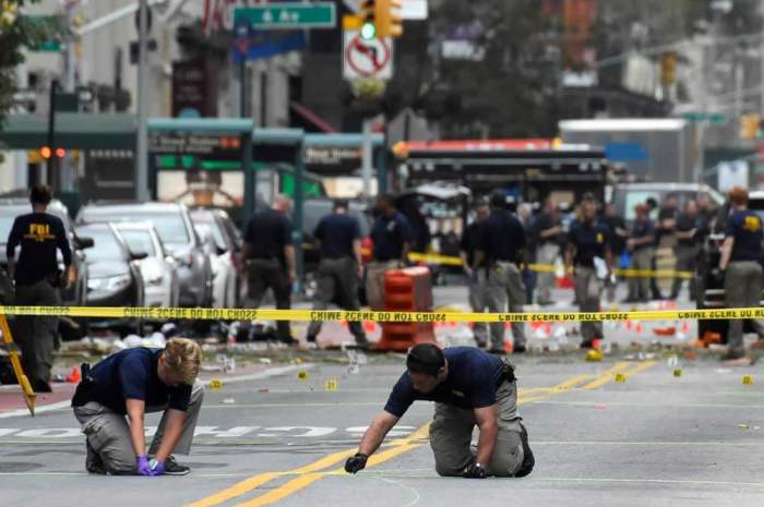 Federal Bureau of Investigation (FBI) officials mark the ground near the site of an explosion in the Chelsea neighborhood of Manhattan, New York, U.S. September 18, 2016.