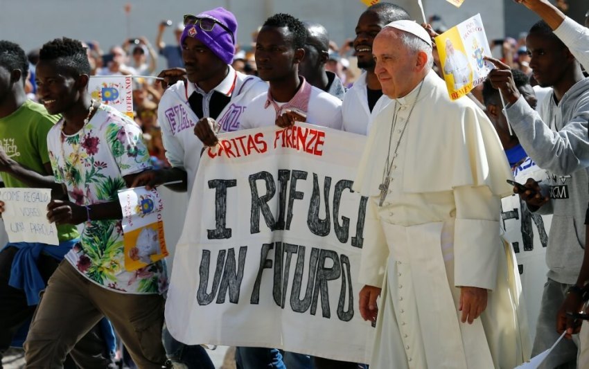 Pope Francis waves as he arrives, flanked by a group of refugees, to lead his Wednesday general audience in Saint Peter's square at the Vatican June 22, 2016.