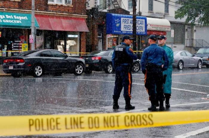 Police officers stand guard while law enforcement officers search an address during an investigation into Ahmad Khan Rahami, who was wanted for questioning in an explosion in New York, which authorities believe is linked to the explosive devices found in New Jersey, in Elizabeth, September 19, 2016.