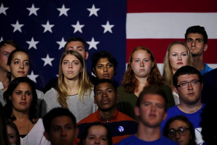 Students listen U.S. Democratic presidential candidate Hillary Clinton (not pictured) as she speaks during a campaign event at Temple University in Philadelphia, Pennsylvania, September 19, 2016.