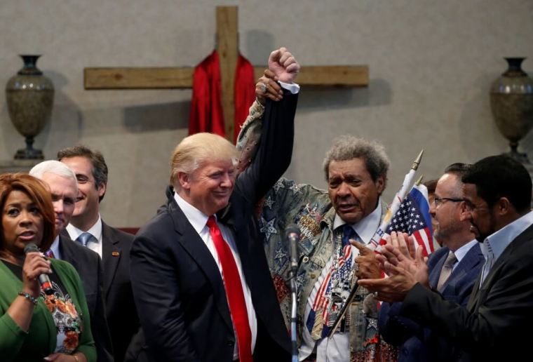 Promoter Don King (center R) raises the hand of Republican presidential nominee Donald Trump (center L) in triumph at a gathering of clergy at the New Spirit Revival Center in Cleveland Heights, Ohio, U.S. September 21, 2016.