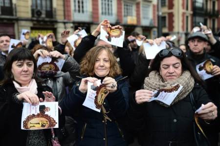 Members of Spanish trade union CCOO tear up sheets of paper printed with the cover of the book "Get Married and be Submissive," by Italian author Costanza Miriano, together with the picture of the Archbishop of Granada Javier Martinez during a protest on the International Day for the Elimination of Violence Against Women, in Bilbao November 25, 2013.