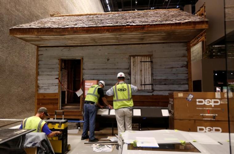 Workers put finishing touches on the Point of Pines Plantation slave cabin display during the media preview day the National Museum of African American History and Culture on the National Mall in Washington September 14, 2016. The museum will open to the public on September 24.
