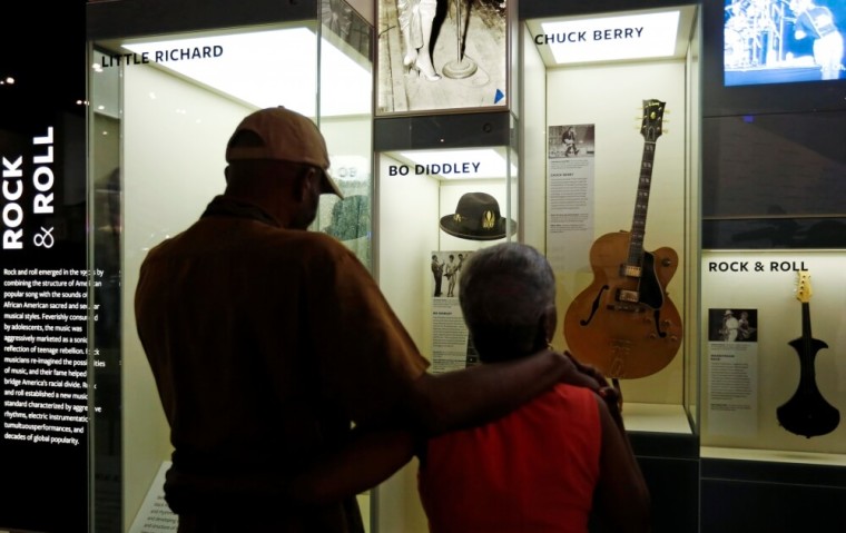 Ellas McDaniel Jr., a son of music legend Bo Diddley puts his arm around former Bo Diddley background singer Gloria Jolivet as they stand in front a Bo Diddley display during a media preview at the National Museum of African American History and Culture on the National Mall in Washington, U.S., September 14, 2016. The museum will open to the public on September 24.