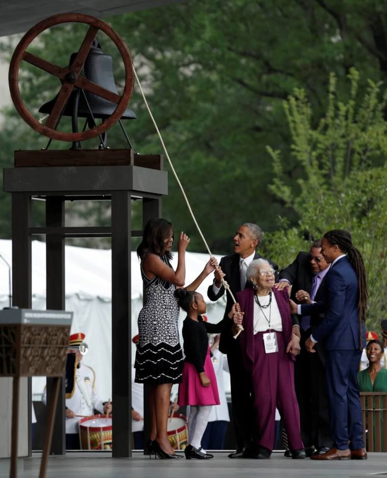U.S. President Barack Obama with first lady Michelle Obama and the Bonner family ring the onstage bell during dedication and grand opening of the Smithsonian Institution's National Museum of African American History and Culture in Washington, U.S., September 24, 2016.