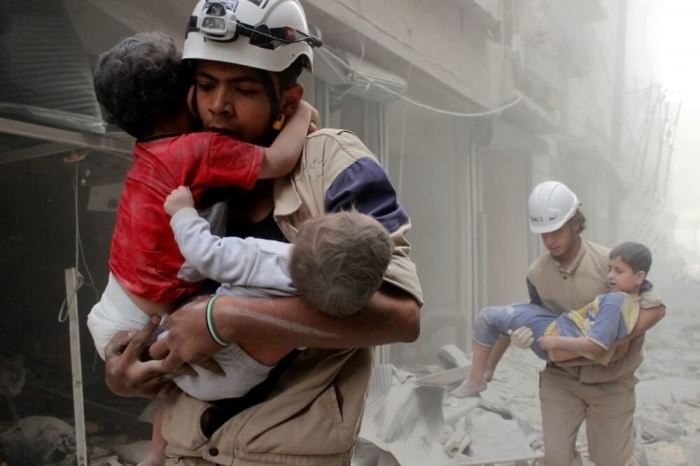 Members of the Civil Defence rescue children after what activists said was an air strike by forces loyal to Syria's President Bashar al-Assad in al-Shaar neighbourhood of Aleppo, Syria, June 2, 2014.