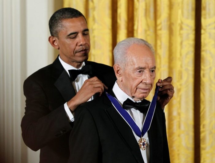 U.S. President Barack Obama (L) presents the Presidential Medal of Freedom to Israeli President Shimon Peres in the East Room of the White House in Washington in this June 13, 2012, file photo.