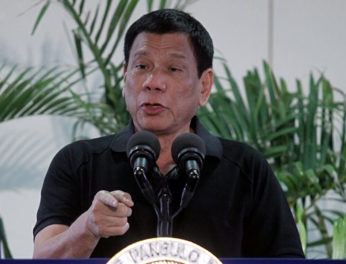 Philippines President Rodrigo Duterte gestures during a news conference upon his arrival from a state visit in Vietnam at the International Airport in Davao city, Philippines, September 30, 2016.