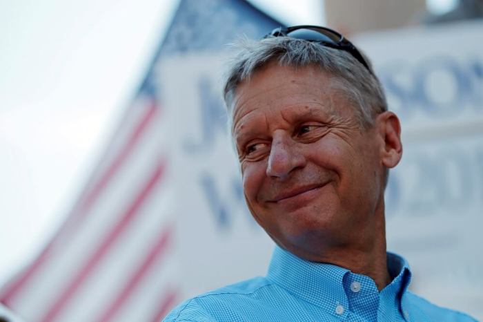 Libertarian presidential candidate Gary Johnson listens as his running mate vice presidential candidate Bill Weld speaks at a campaign rally in Boston, Massachusetts, U.S., August 27, 2016.